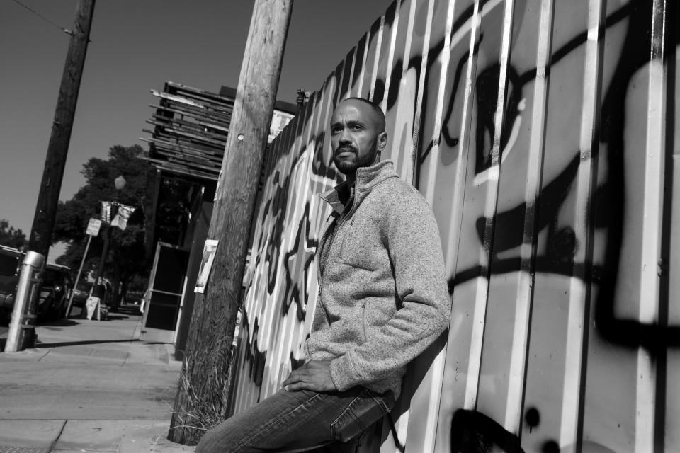 Jeffrey Rambo stands against a wall in the Barrio Logan neighborhood of San Diego.