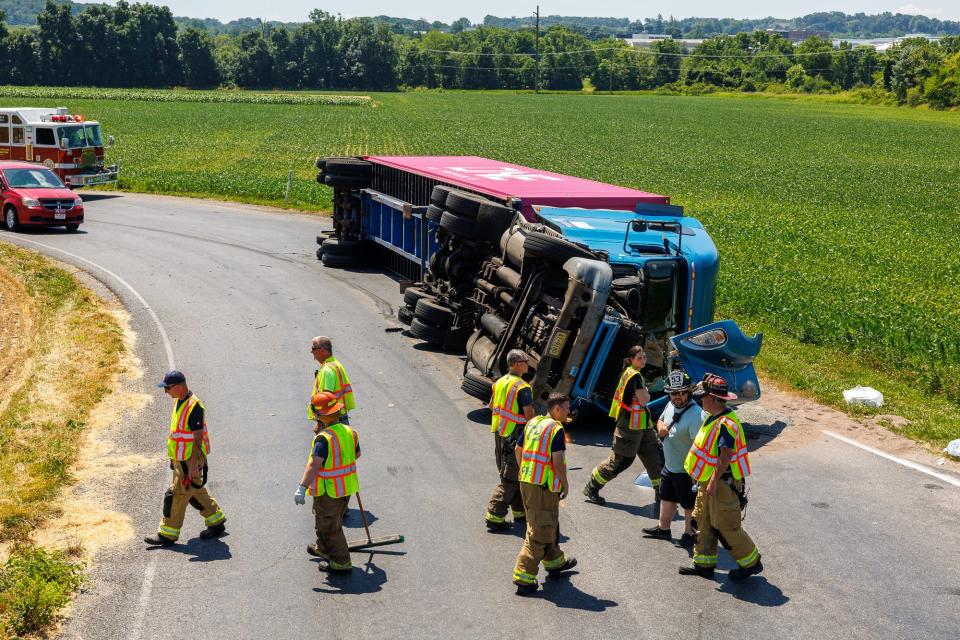 Emergency crews work at the scene where a tractor-trailer rolled over near the intersection of Karen Lane and Gitts Run Road, Friday, June 21, 2024, in Penn Township. The driver of the tractor-trailer was transported to the hospital.