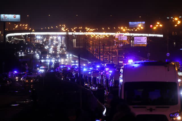 <p>STRINGER/AFP via Getty</p> Ambulances are seen at the scene of the shooting at the Crocus City Hall concert hall in Krasnogorsk, outside Moscow