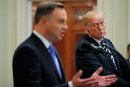U.S. President Donald Trump listens to Poland's President Andrzej Duda during a joint news conference in the East Room of the White House in Washington, U.S., September 18, 2018. REUTERS/Brian Snyder