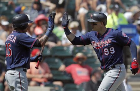 Jun 28, 2018; Chicago, IL, USA; Minnesota Twins first baseman Logan Morrison (99) celebrates his home run against the Chicago White Sox with teammate Minnesota Twins shortstop Ehire Adrianza (16) during the seventh inning at Guaranteed Rate Field. Mandatory Credit: Jim Young-USA TODAY Sports