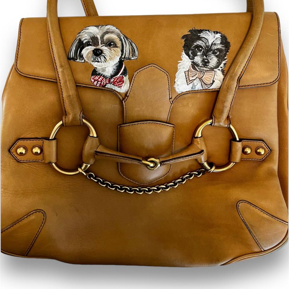 A bag with two dog portraits painted onto it