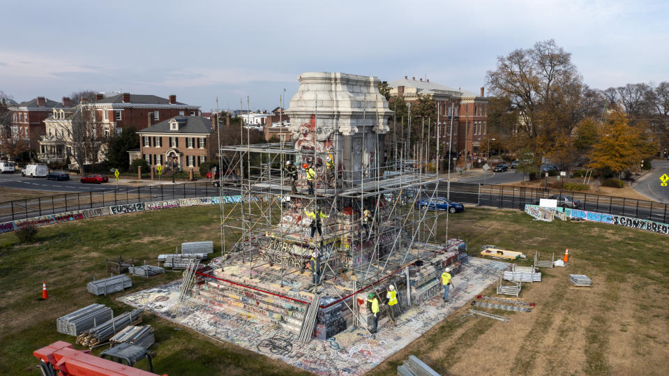 Workers install scaffolding as they prepare to remove the pedestal that once held the statue of Confederate General Robert E. Lee on Monument Avenue Monday Dec 6, 2021, in Richmond, Va. Virginia Gov. Ralph Northam ordered the pedestal removed and the land granted to the City of Richmond. (AP Photo/Steve Helber)