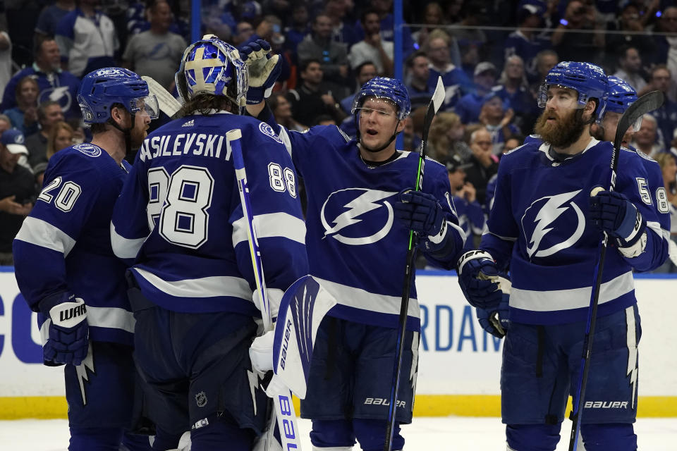 Tampa Bay Lightning goaltender Andrei Vasilevskiy (88) celebrates with center Blake Coleman (20), left wing Ondrej Palat (18), and defenseman David Savard (58) after the team defeated the New York Islanders during Game 2 of an NHL hockey Stanley Cup semifinal playoff series Tuesday, June 15, 2021, in Tampa, Fla. (AP Photo/Chris O'Meara)