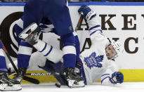 Toronto Maple Leafs center Nazem Kadri (43) gets knocked down by Tampa Bay Lightning defenseman Braydon Coburn during the first period of an NHL hockey game Thursday, Dec. 13, 2018, in Tampa, Fla. (AP Photo/Chris O'Meara)