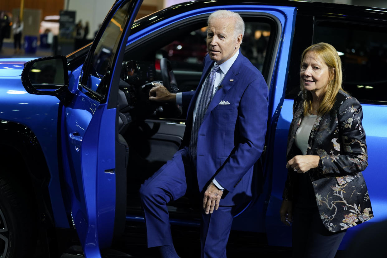 Mary Barra, CEO of General Motors, stands with President Joe Biden during a tour of the Detroit Auto Show, Wednesday, Sept. 14, 2022, in Detroit. (AP Photo/Evan Vucci)
