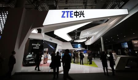 Visitors check out products at the ZTE stand at the Mobile World Congress in Barcelona, February 24, 2014. REUTERS/Albert Gea