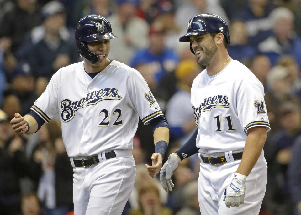 Milwaukee Brewers' Mike Moustakas (11) celebrates with Christian Yelich (22) after hitting a two-run home run during the second inning of a baseball game against the Washington Nationals Wednesday, May 8, 2019, in Milwaukee. (AP Photo/Aaron Gash)