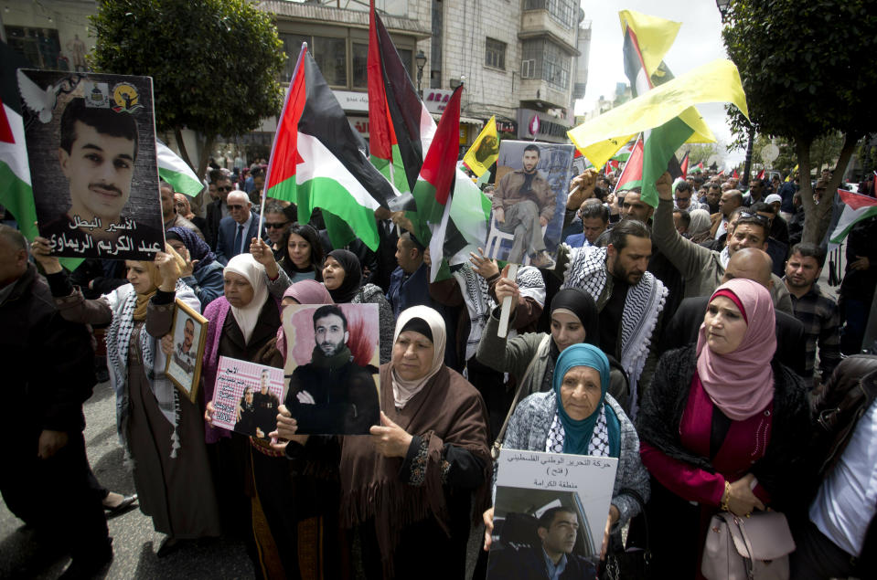 Relatives of Palestinians held in Israeli jails hold their portraits during a protest to mark "Prisoners Day" in the West Bank city of Ramallah, Wednesday, April 7, 2019.(AP Photo/Majdi Mohammed)