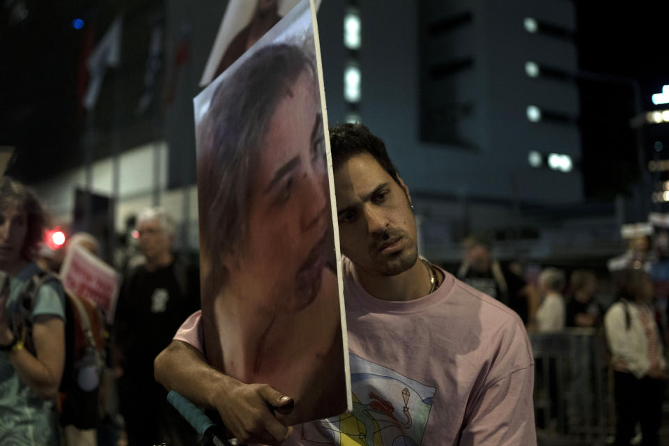 A protester holds a large photo of Agam Berger in Hamas captivity in the Gaza Strip, as families and their supporters march to call on Israeli Prime Minister Benjamin Netanyahu's government to make a deal to free their loved ones, in Tel Aviv, Israel, Wednesday, May 8, 2024. (AP Photo/Maya Alleruzzo)