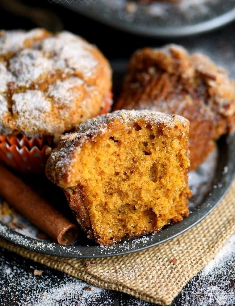 Pumpkin muffins topped with powdered sugar.