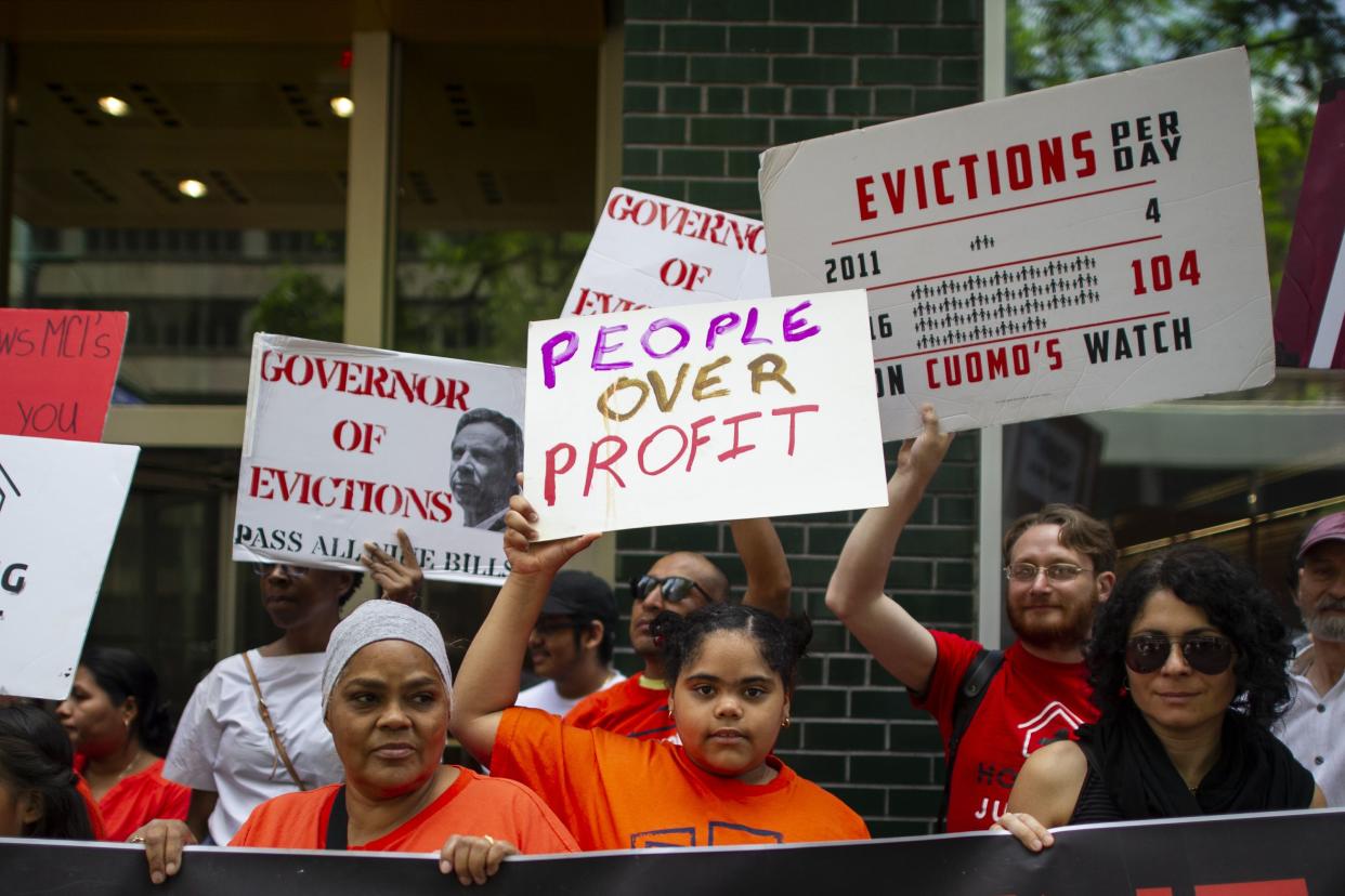 People rally to stop evictions. 