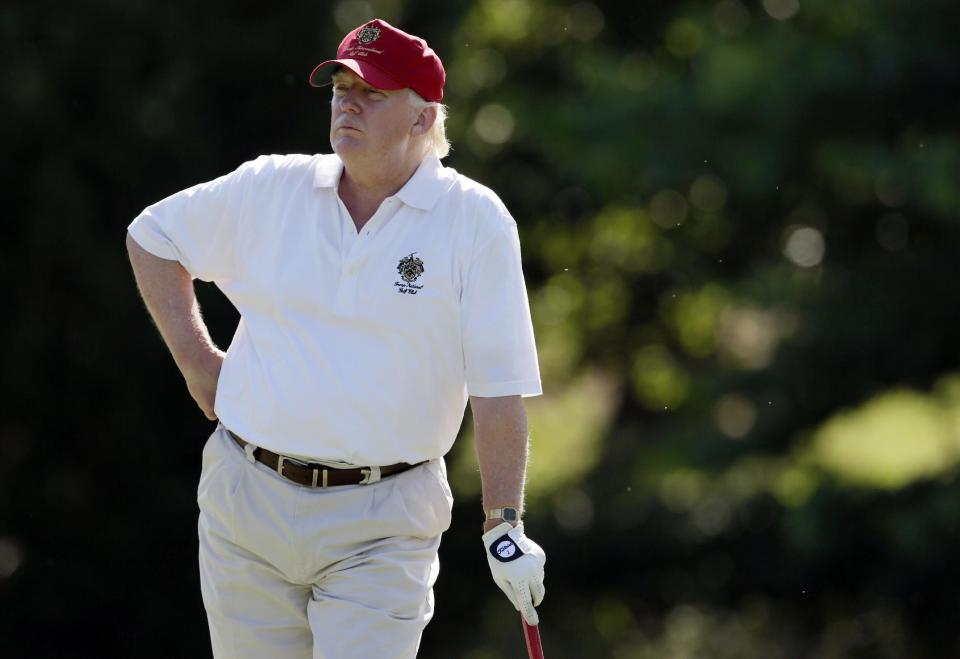 FILE - In this June 27, 2012, file photo, Donald Trump stands on the 14th fairway during a pro-am round of the AT&T National golf tournament at Congressional Country Club in Bethesda, Md. If they stick to schedule, Japanese Prime Minister Shinzo Abe and Trump will spend more time on the fairway than at the White House. After facing off on some divisive issues in Washington on Friday, Feb. 10, 2017, they are jetting to Florida, where they will turn to something they have in common on Saturday: a love of golf. (AP Photo/Patrick Semansky, File)