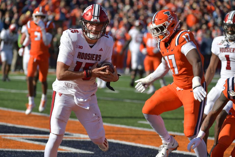 Nov 11, 2023; Champaign, Illinois, USA; Indiana Hoosiers quarterback Brendan Sorsby (15) scores a touchdown during the first half against the Illinois Fighting Illini at Memorial Stadium. Mandatory Credit: Ron Johnson-USA TODAY Sports