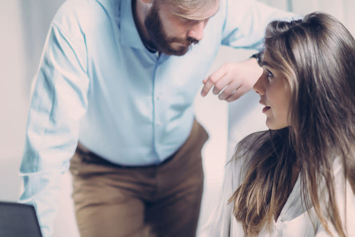 a man leaning in close to a woman who looks uncomfortable