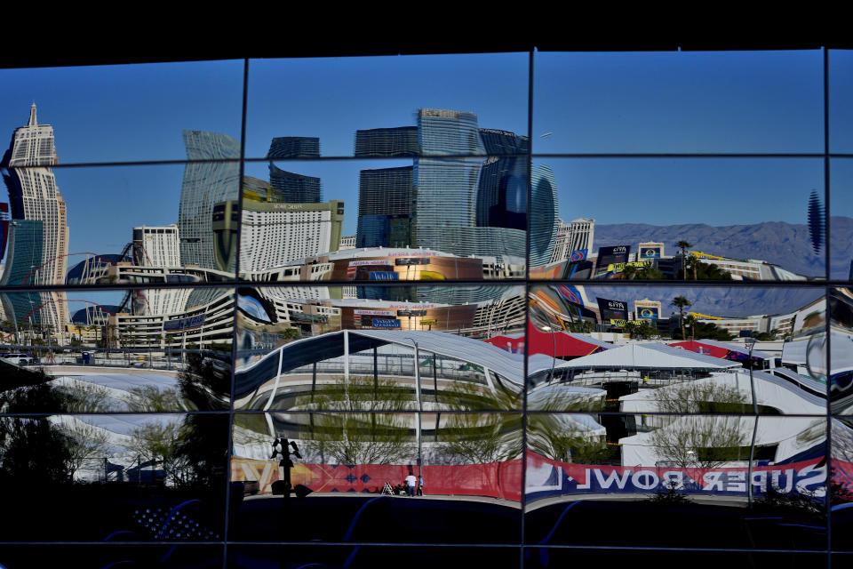 The Las Vegas Strip is reflected in Allegiant Stadium window panes as crews prepare for Super Bowl 58, Tuesday, Jan. 30, 2024, in Las Vegas. (AP Photo/Matt York)