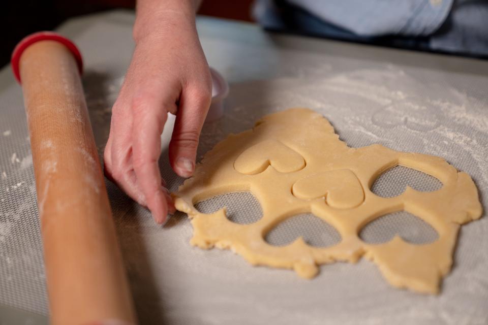 Jacqueline Brock makes Bitt of Sugar cookies at her West Des Moines home.