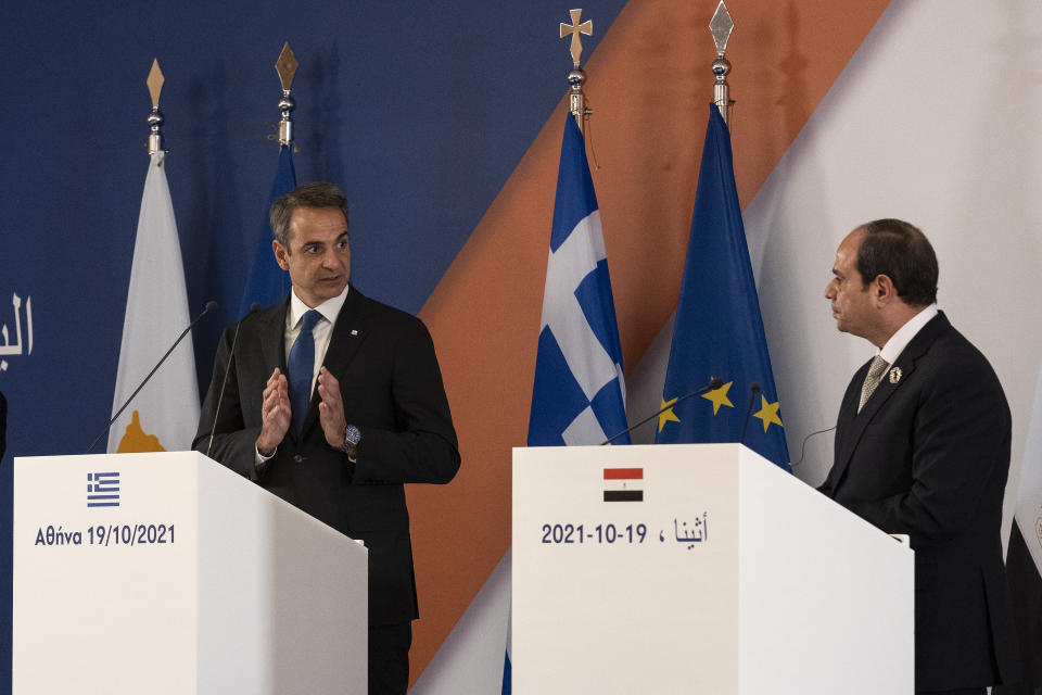 Greece's Prime Minister Kyriakos MItsotakis, left, makes statements during a joint news briefing with Egypt's President Abdel Fattah al-Sisi, right and Cyprus' President Nicos Anastasiades, not pictured, in Athens, Greece, Tuesday, Oct. 19, 2021. Athens hosts the 9th trilateral meeting between the three countries. (AP Photo/Yorgos Karahalis)