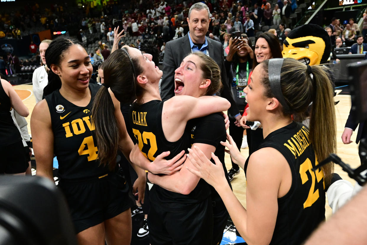 Caitlin Clark, center, celebrates with her Iowa Hawkeyes teammates after they beat South Carolina in the Final Four of the NCAA women's tournament at American Airlines Center in Dallas on March 31, 2023. (Ben Solomon/NCAA Photos via Getty Images)