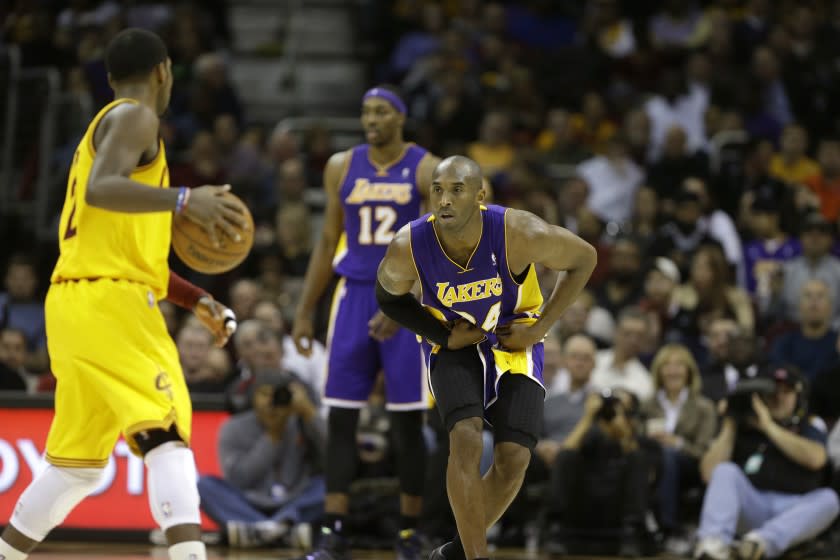 Lakers' Kobe Bryant defends against Cleveland Cavaliers' Kyrie Irving on Dec. 11, 2012.