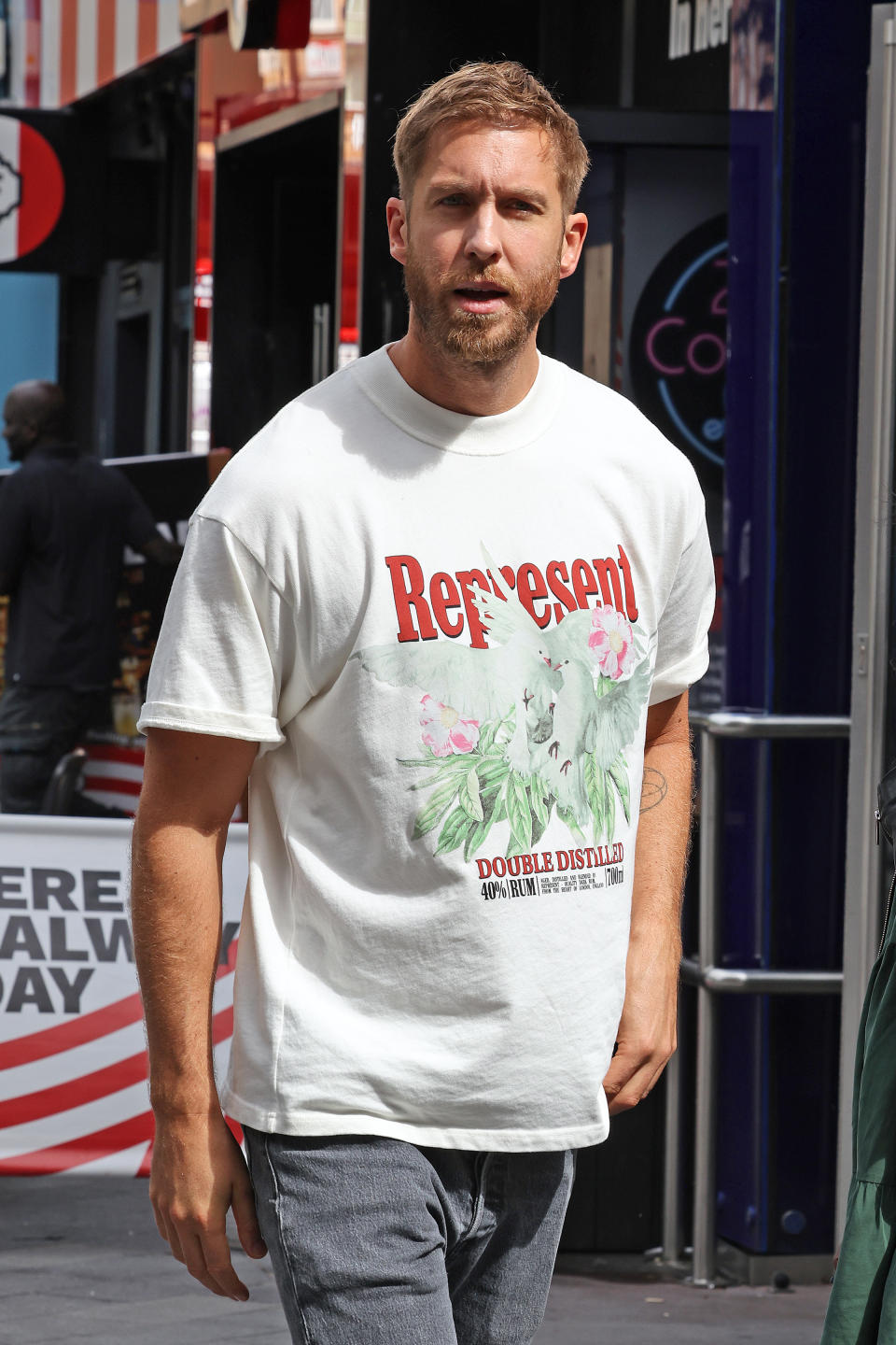 Close-up of Calvin/Adam in a "Represent Double Distilled" T-shirt and jeans