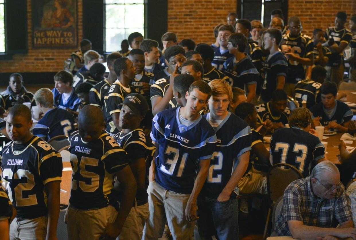 <span class="caption">Football players from Lee Central High School in Bishopville, South Carolina, share a meal with players from the Robert E. Lee Academy. Lee County in South Carolina is still segregated.</span> <span class="attribution"><a class="link " href="https://www.gettyimages.com/detail/news-photo/footballs-players-from-lee-central-high-school-gather-to-news-photo/458152352?adppopup=true" rel="nofollow noopener" target="_blank" data-ylk="slk:Jahi Chikwendiu/The Washington Post via Getty Images;elm:context_link;itc:0;sec:content-canvas">Jahi Chikwendiu/The Washington Post via Getty Images</a></span>