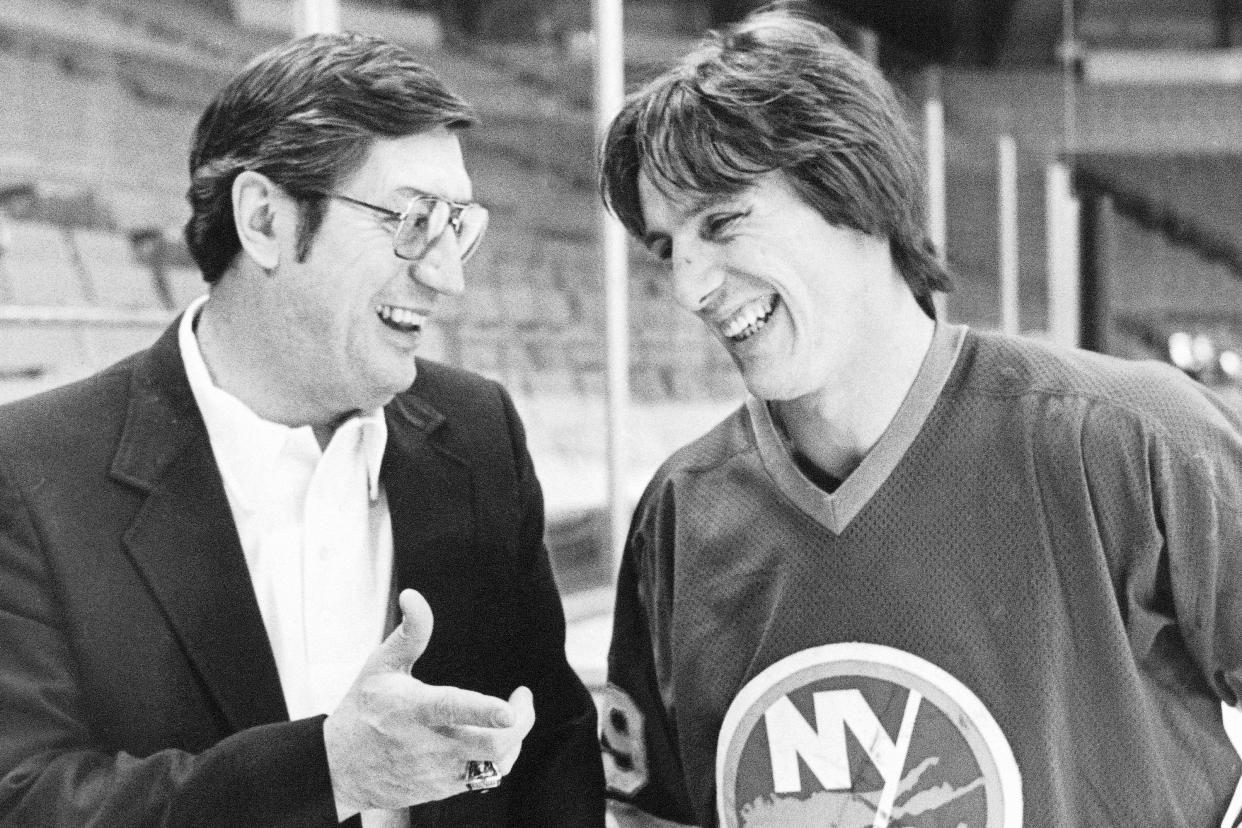 FILE - N.Y. Islanders coach Al Arbour, left, talks with his top scorer Mike Bossy during a break in practice in Denver, March 17, 1982. Bossy, one of hockey's most prolific goal-scorers and a star for the New York Islanders during their 1980s dynasty, died Thursday, April 14, 2022, after a battle with lung cancer. He was 65. (AP Photo/Ed Andrieski, File)