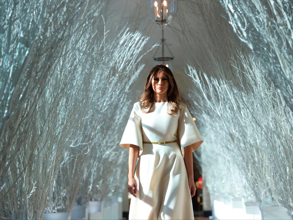 First Lady Melania Trump walks through Christmas decorations in the East Wing, 27 November 2017AFP via Getty Images