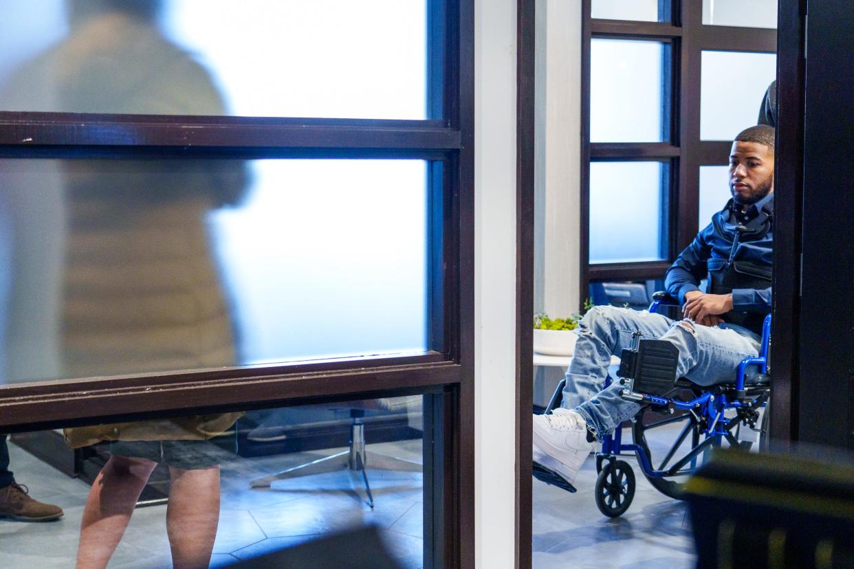 Anthony Maclin is wheeled Feb. 6, 2023, by his father, Anthony Maclin Sr., into a news conference.