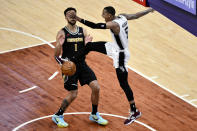 San Antonio Spurs guard Dejounte Murray (5) reacts after dunking next to Memphis Grizzlies forward Kyle Anderson (1) during the first half of an NBA basketball Western Conference play-in game Wednesday, May 19, 2021, in Memphis, Tenn. (AP Photo/Brandon Dill)