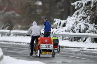 Two cyclists make their way along the A93 in Spittal of Glenshee, Scotland.