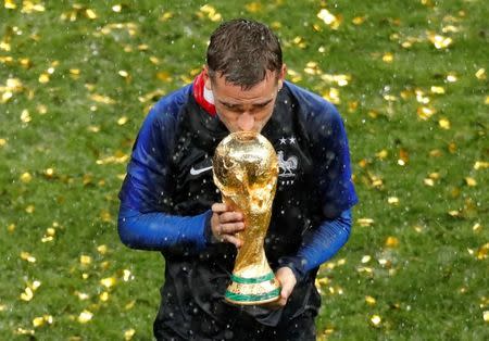 Soccer Football - World Cup - Final - France v Croatia - Luzhniki Stadium, Moscow, Russia - July 15, 2018 France's Antoine Griezmann kisses the trophy to celebrate winning the World Cup REUTERS/Christian Hartmann