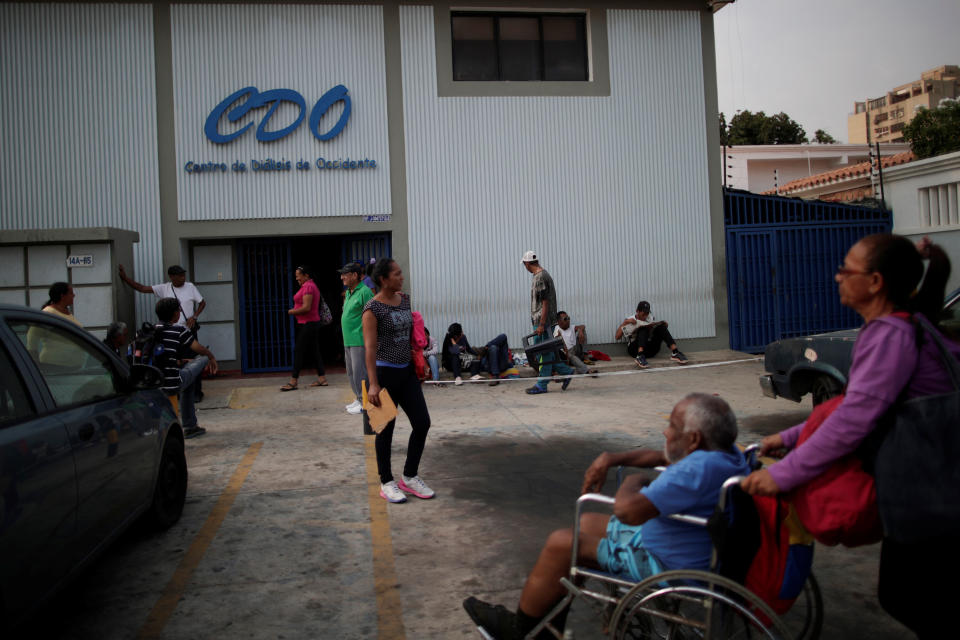 Patients with kidney disease wait with their relatives in front of a dialysis center for electricity to return during a blackout in Maracaibo, Venezuela. (Photo: Ueslei Marcelino/Reuters)