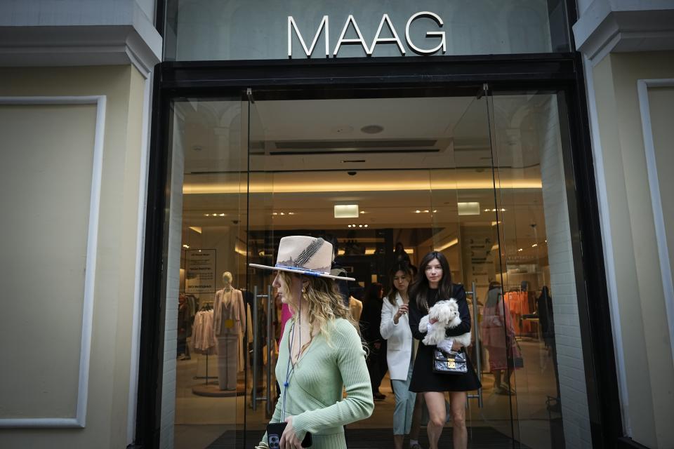 FILE - A woman exits a newly opened Maag store, a former Zara flagship store, in Moscow, Russia, Thursday, April 27, 2023. When Russia invaded Ukraine, companies were quick to respond, some announcing they would get out of Russia immediately, others vowed to curtail sales and new investment. More than a year later, it’s clear: Leaving Russia isn't as easy as the first announcements might have made it seem. (AP Photo/Alexander Zemlianichenko, File)