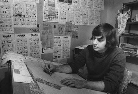 Akron-born cartoonist Tom Batiuk works at a drawing board in 1972, the year that “Funky Winkerbean” debuted.