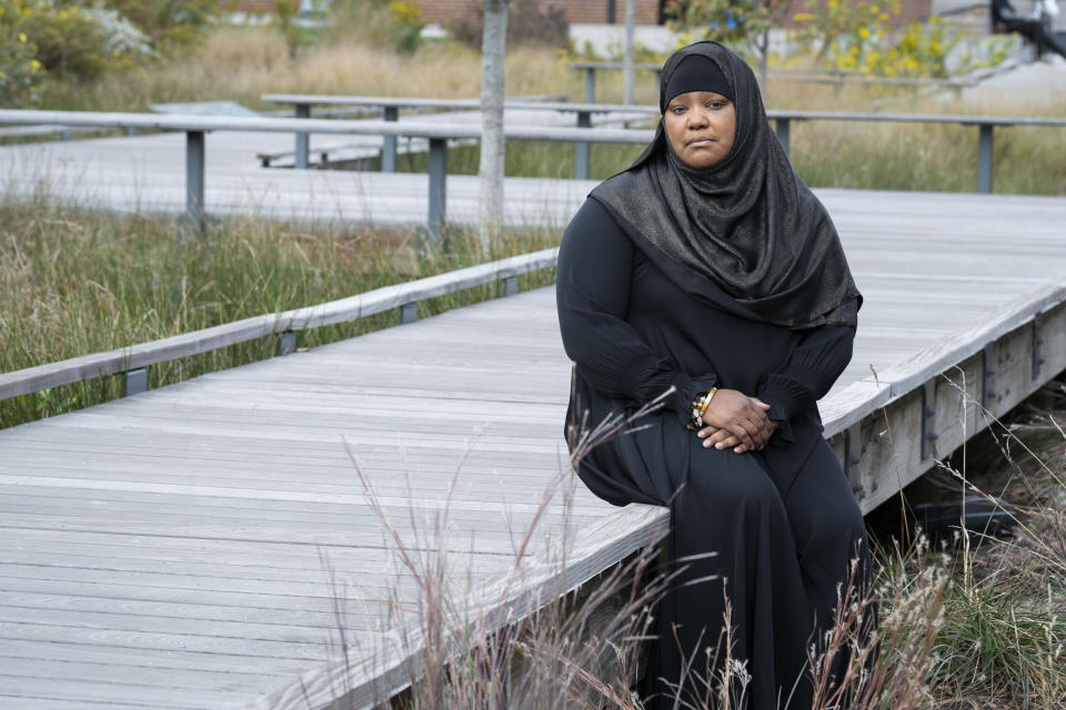 Asiyah Timimi, whose husband was stabbed to death in January 2021, sits on a walk path along Metropolitan Branch Trail on Friday, Oct. 27, 2023 in Washington. (AP Photo/Kevin Wolf)