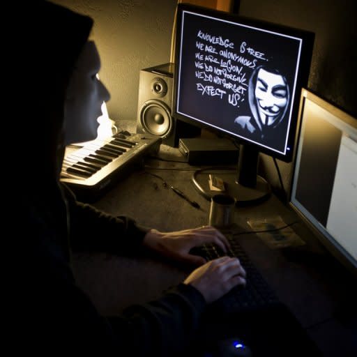 File photo of a masked member of the Anonymous hacker group. A Twitter message and blog post believed to be from the hacker collective has claimed to have obtained large amounts of data from the Justice Department site that it was releasing