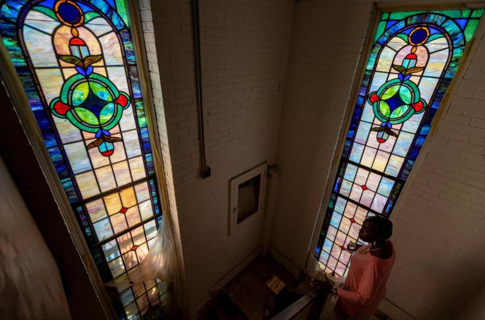 Miami, Florida, July 24, 2023 - Cecily Robinson-Duffie walks past a pair of stained-glass windows inside St. John Institutional Missionary Baptist Church in Overtown.