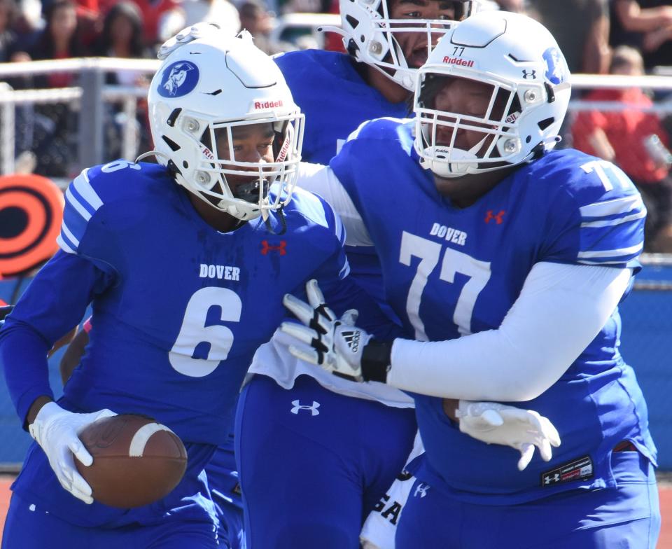 Dover's Taishaun Allen (6) and Jason Hoskins celebrate a Senators score against Smyrna.