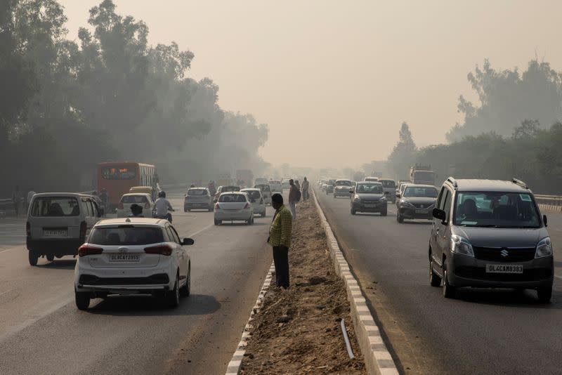 Traffic moves on a smoggy morning in New Delhi