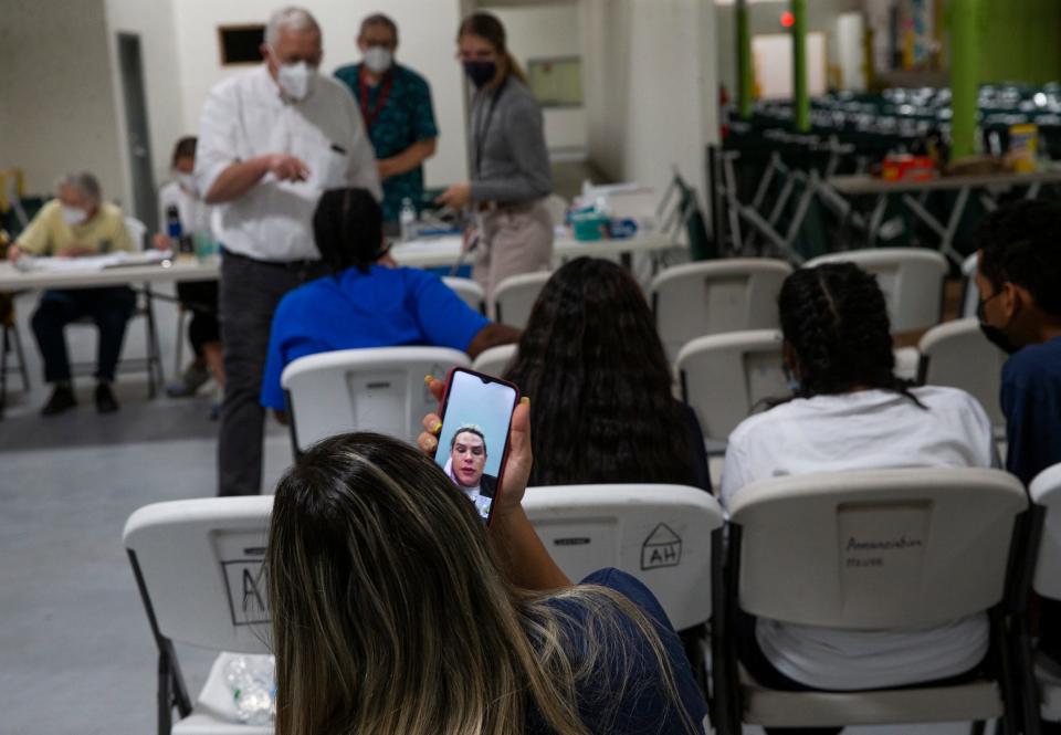 Migrants speak to their loved ones at the migrant shelter Annunciation House in El Paso, Texas on Thurs., March 24, 2022. 