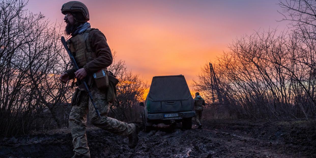 soldier on desolate road during sunset