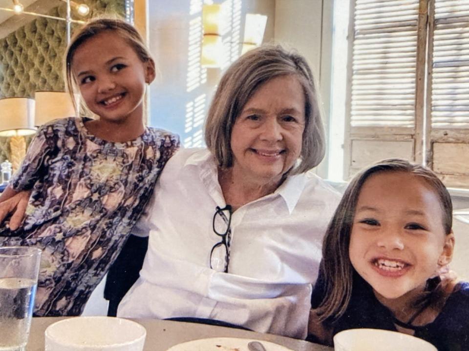 Dianna Phillips in the kitchen with granddaughters Jolie (in print top) and Mia.