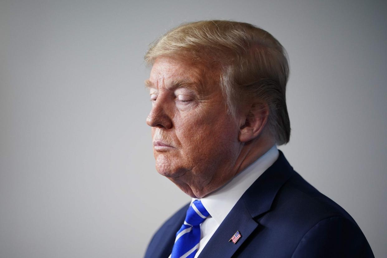 Donald Trump appears at a White House briefing on the coronavirus pandemic: AFP via Getty Images