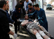 <p>People carry an injured man after a blast in Kabul, Afghanistan, Jan. 27, 2018. (Photo: Mohammad Ismail/Reuters) </p>