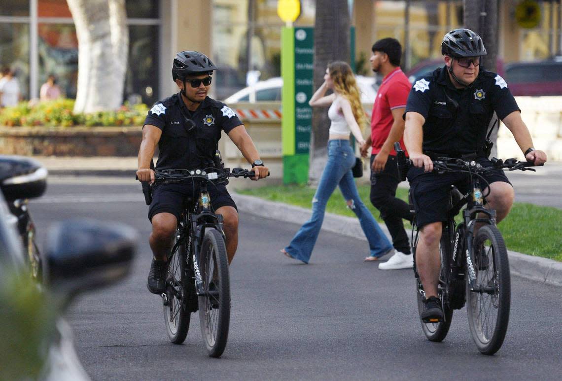 Fresno police officers Luke Tran, left, and Dustin Freeman, right, patrol River Park Saturday afternoon, July 30, 2022 in Fresno. The rekindling of the bike patrols has been a welcome aspect of community policing, said Freeman.