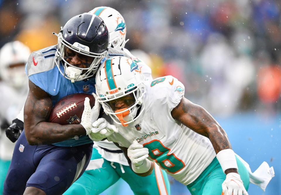 Dolphins safety Jevon Holland makes a play on Titans receiver A.J. Brown in a game in January, 2022.