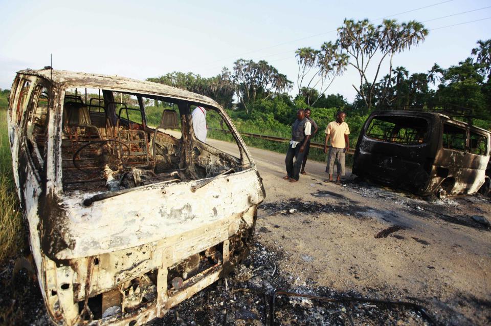 Wreckages of burnt cars are seen along the main road to Lamu from Mpeketoni after unidentified gunmen attacked the coastal Kenyan town of Mpeketoni, June 16, 2014. (REUTERS/Joseph Okanga)