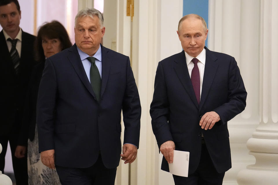 Russian President Vladimir Putin, right, and Hungarian Prime Minister Viktor Orban enter a hall to attend a joint news conference following their talks in the Kremlin in Moscow, Russia, Friday, July 5, 2024. Hungarian Prime Minister Viktor Orban visited Moscow on Friday for a rare meeting by a European leader with Russian President Vladimir Putin and discussed peace proposals for Ukraine, which triggered condemnation from Kyiv and some European leaders and officials. (AP Photo/Alexander Zemlianichenko)