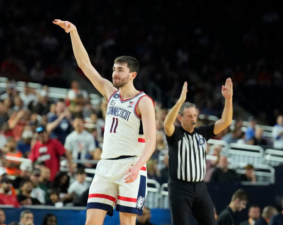 Connecticut forward Alex Karaban celebrates his end-of-half 3-pointer in the Huskies' Final Four win over Miami.